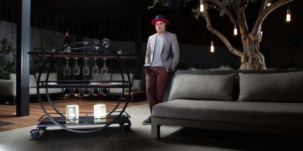 Chris Adams standing next to a fully loaded Cartwheel Mixology Cart