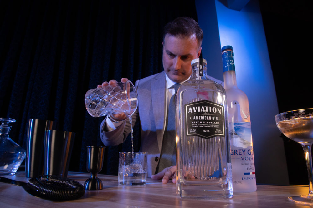 Chris Adams pouring a drink on a Foss Mixology cart